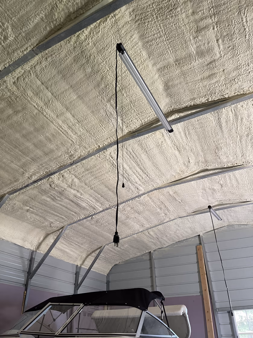 Roofline spray foam image from a project with exposed framing and decking.