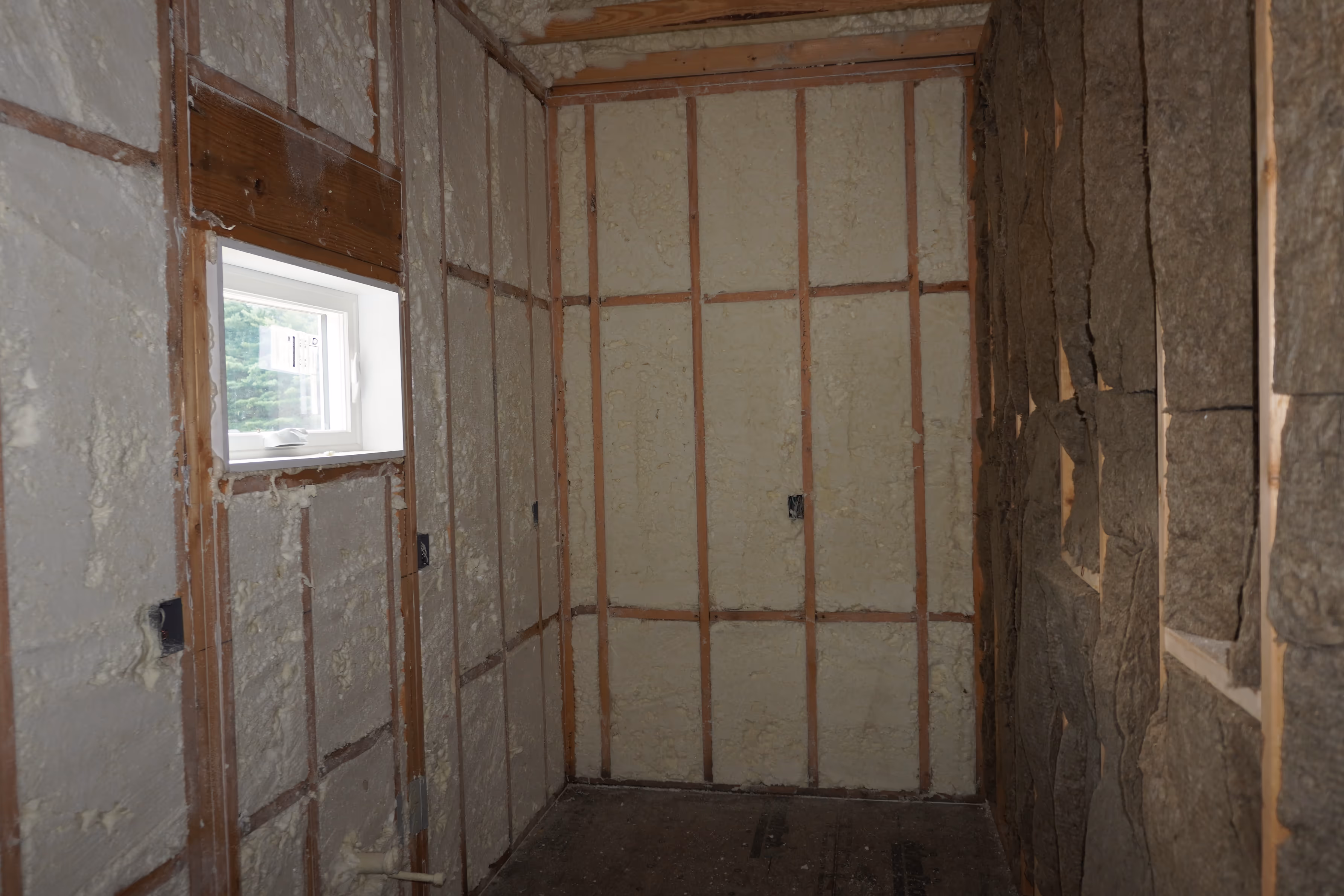 Spray foam coverage around corners, cavities, and utility framing.