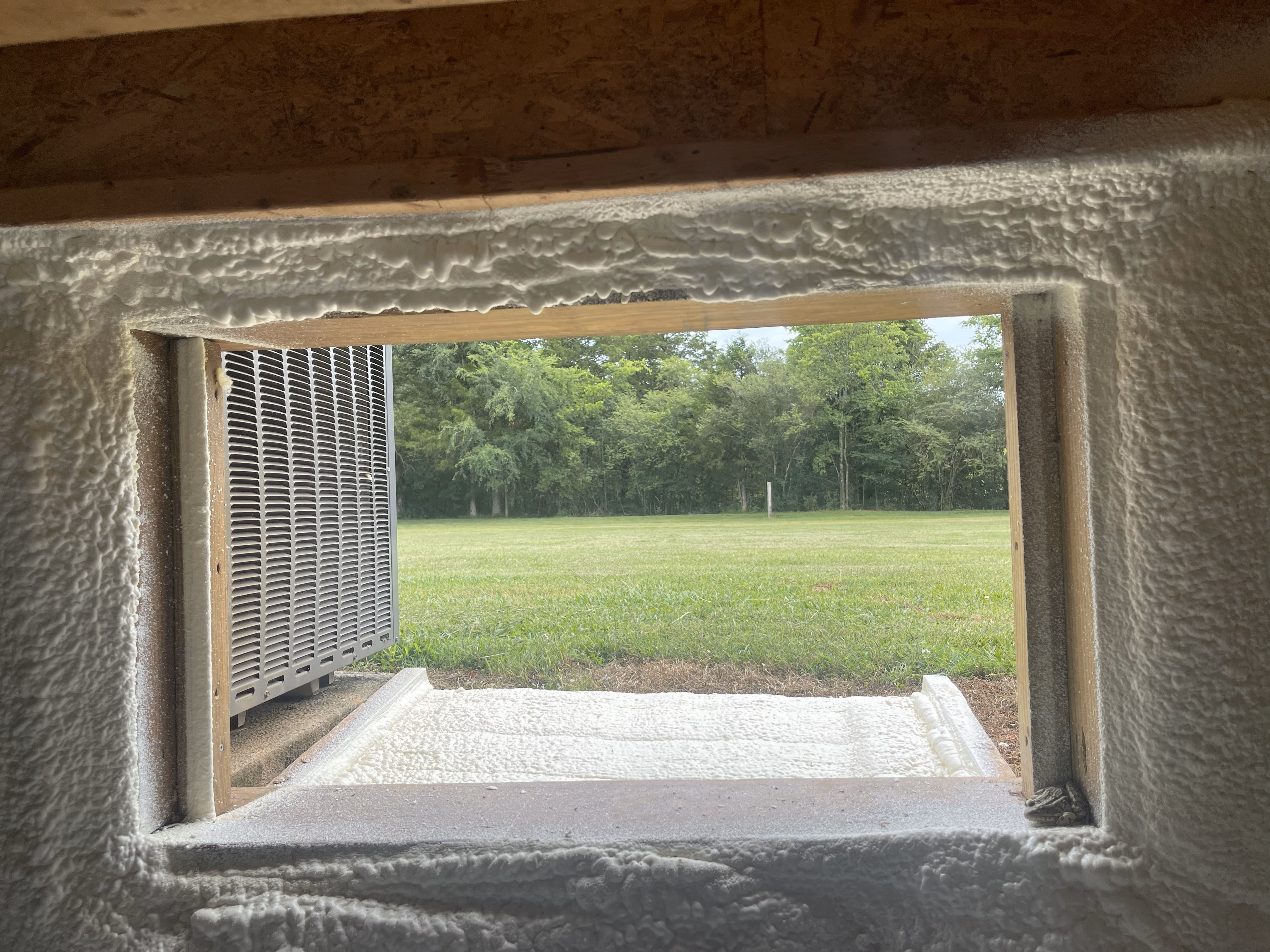 Basement framing insulated with spray foam at a Nashville-area jobsite.