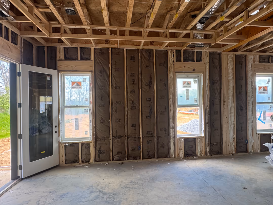 Fiberglass insulation installed in an interior wall and room assembly.
