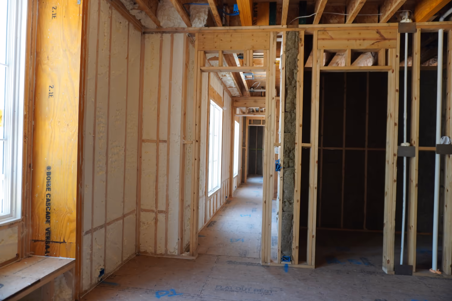 Long hallway framing insulated with spray foam.