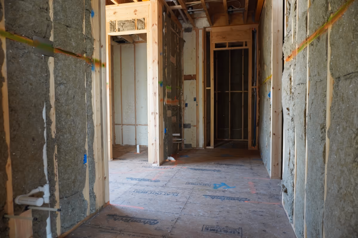Second hallway view of Rockwool insulation installed in framed walls.
