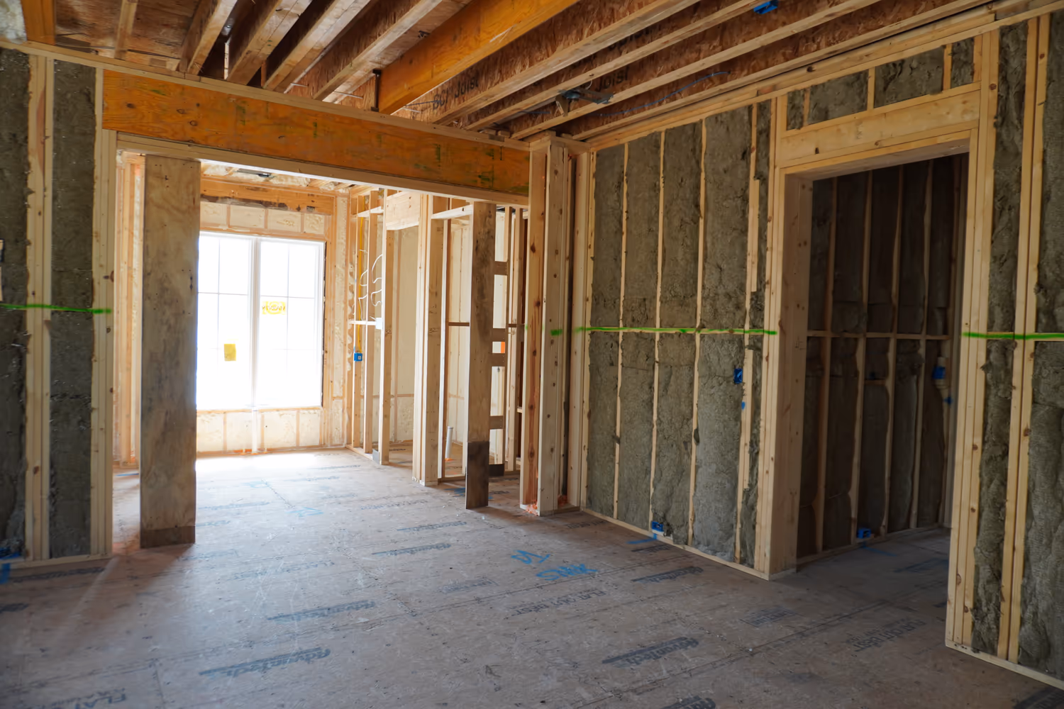 Open room with Rockwool insulation installed through framed walls.