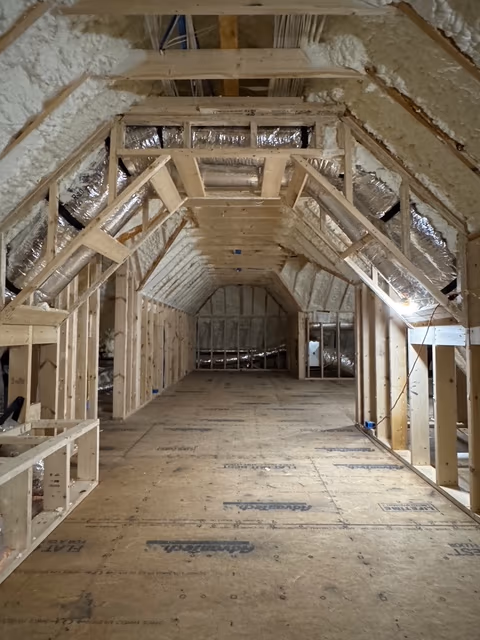 Detail view of spray foam built up along attic framing.