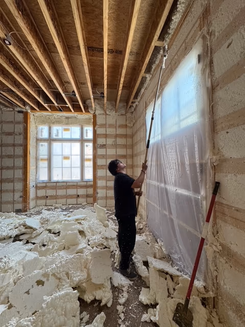 Spray foam cleanup detail with framing prepared for the next trade.