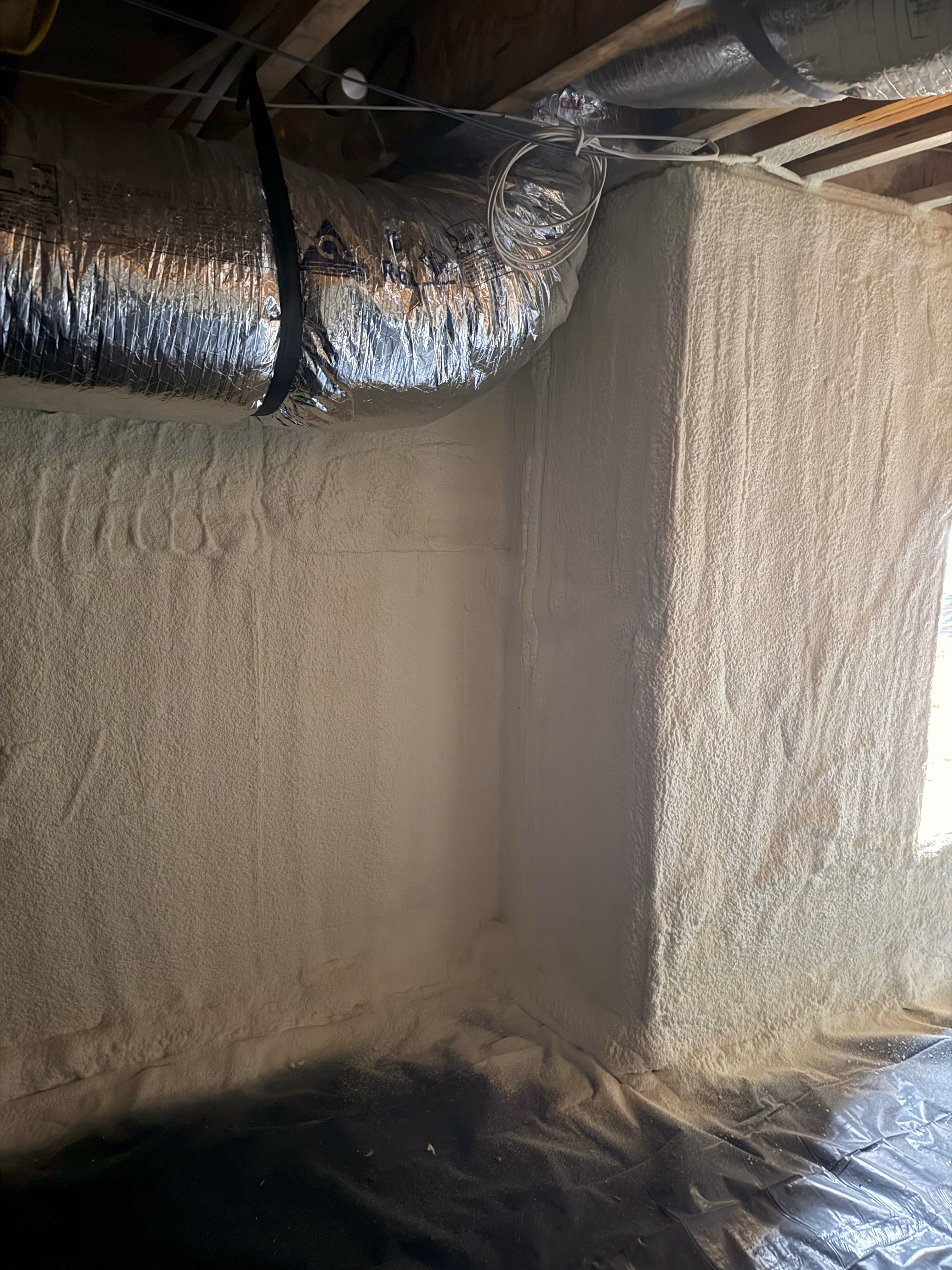 Wall framing insulated with spray foam before finishes are installed.